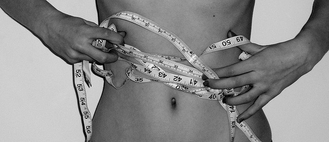 sleep and fat loss - waist with tape measure